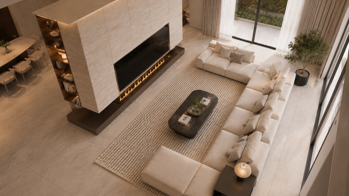 Không gian phòng khách travertine nhìn từ trên cao – sofa kem và lò sưởi đá